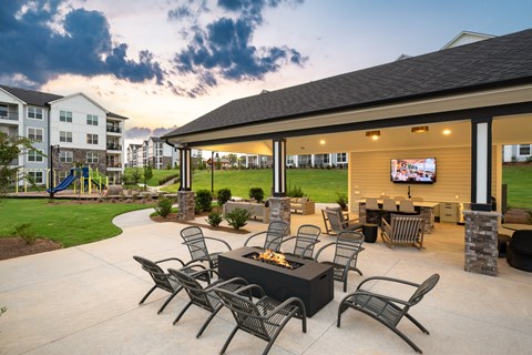 A patio with a table and chairs is set up outside a building.