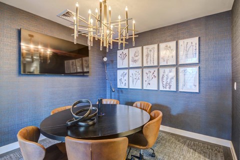 a dining room with blue walls and a chandelier