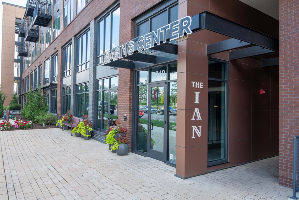 a large brick building with a large metal sign that reads the living center