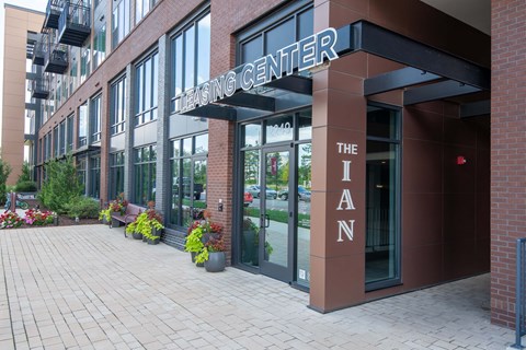 a large brick building with a large metal sign that reads the living center