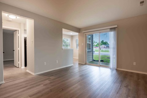 a living room with wood floors and a sliding glass door
