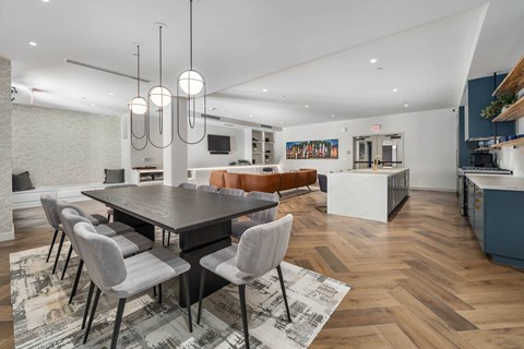 A modern dining room with a large table and chairs.