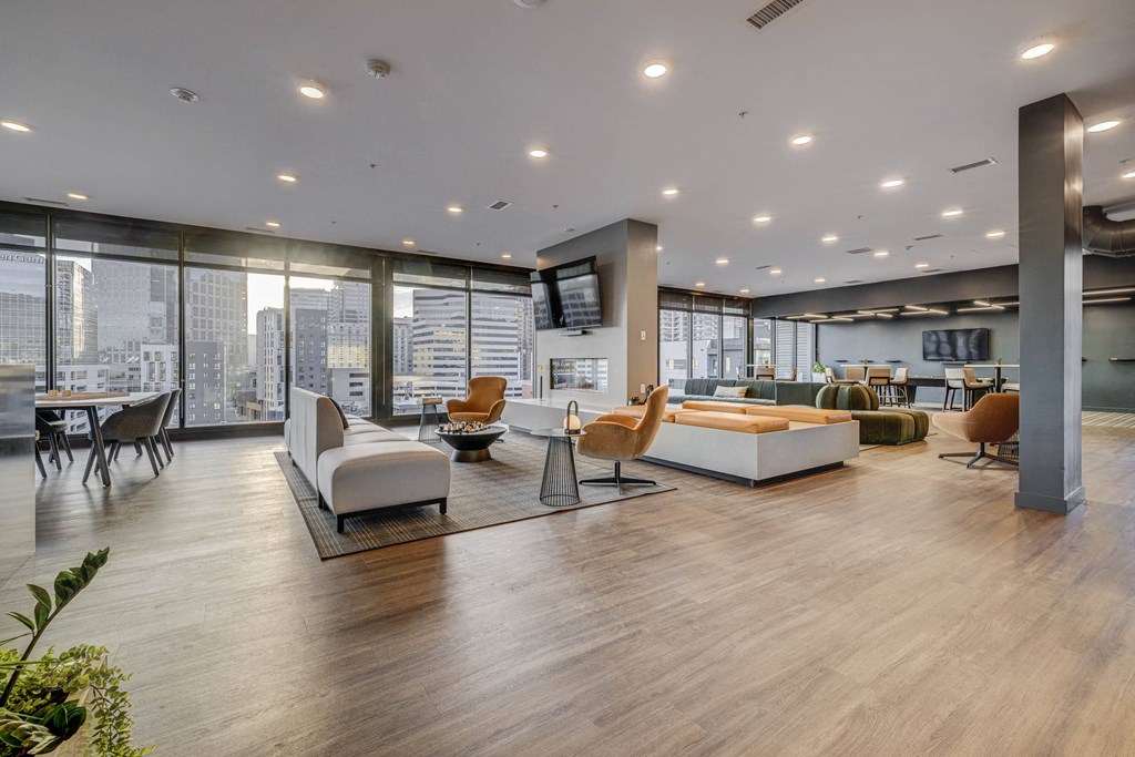 a room with couches and chairs and a view of a city