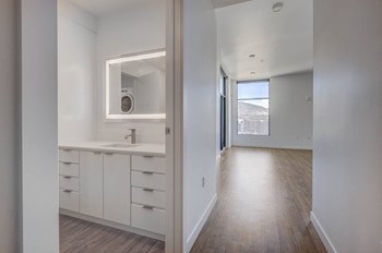 White finished bathroom leading into hallway with wood flooring - Photo Gallery 15