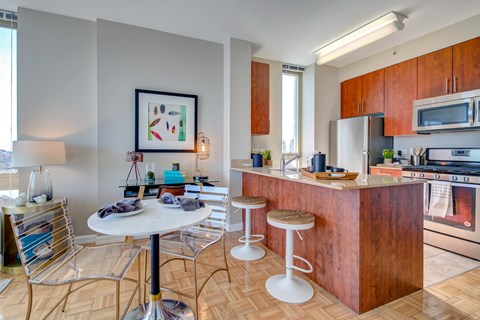 A kitchen with a table and chairs in the middle of the room.