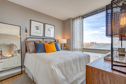 a bedroom with a bed and a view of the water