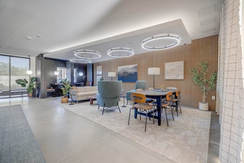 A modern dining area with a table set for six and a large window.