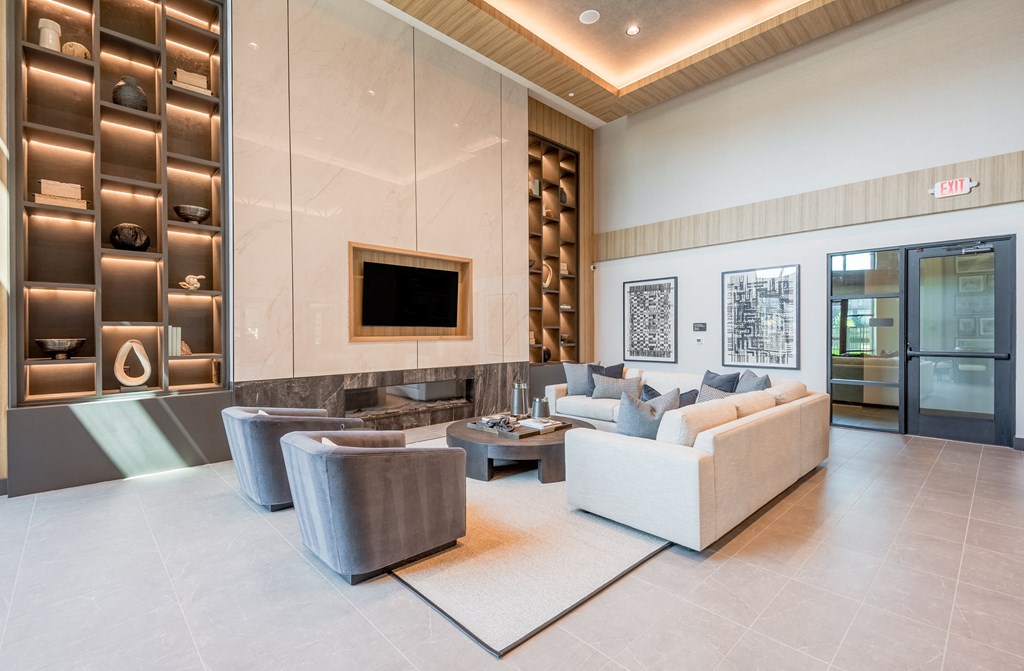 a living room with couches and chairs and a television