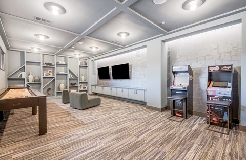 a game room with a pool table and a television