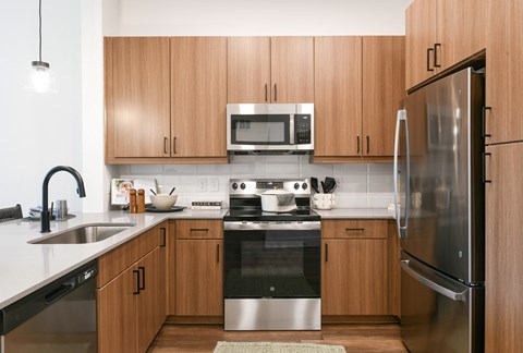 a kitchen with stainless steel appliances and wooden cabinets
