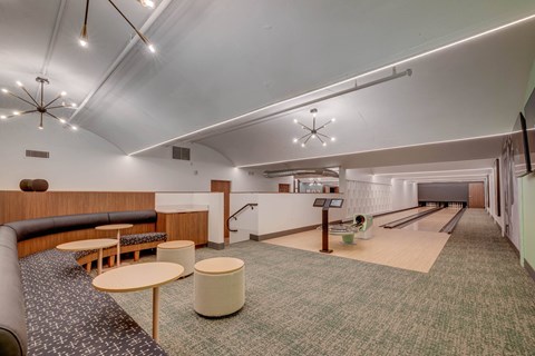 A bowling alley with a lane and a bench.