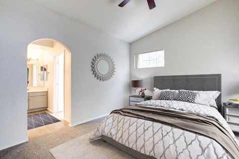a bedroom with a bed and a bathroom with a shower