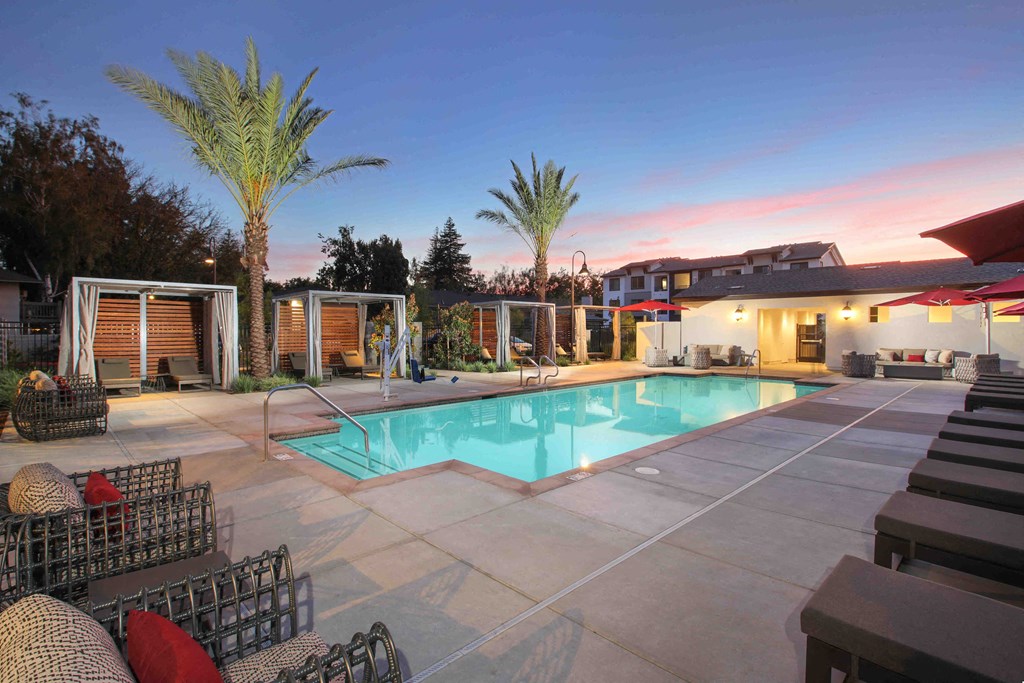 a swimming pool in front of a house with a pool