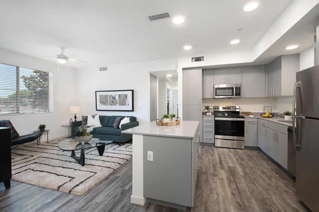 an open living room with a kitchen and a dining room