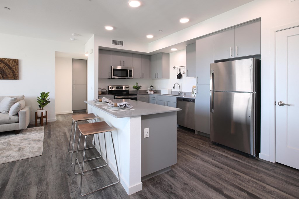 a kitchen with stainless steel appliances and a island with stools
