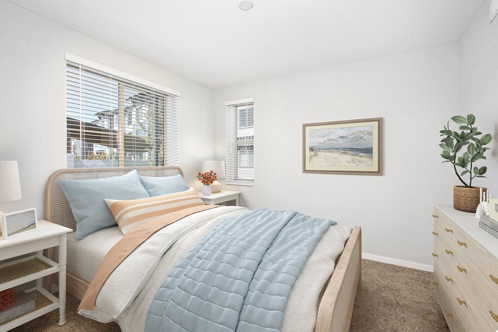 a bedroom with a bed and two windows