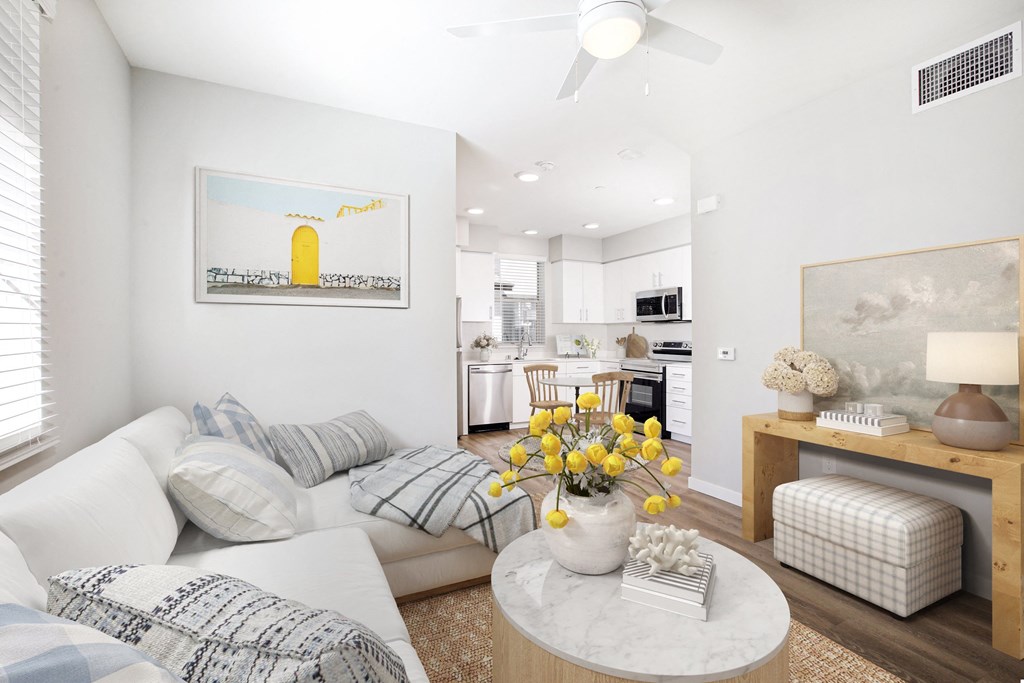 a living room with couches and a table with flowers