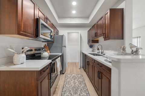 A kitchen with brown cabinets and a white countertop.