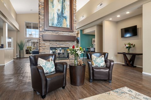 A living room with two chairs and a table.