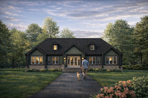 A man walking his dog in front of a house.
