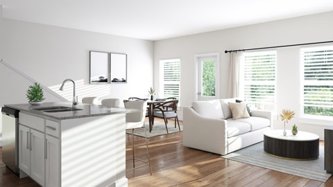 A modern kitchen with white cabinets and a dining area with white furniture.