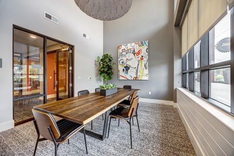 A conference room with a long table and chairs.