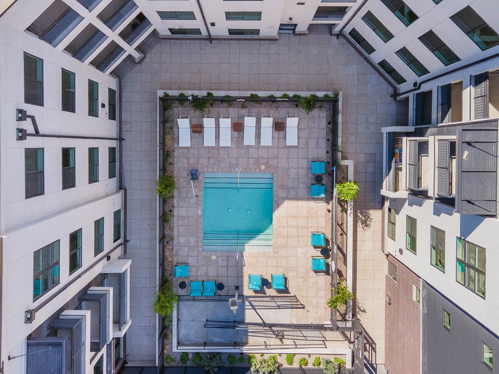 an aerial view of a pool in the middle of a building