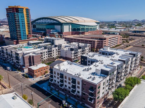 an aerial view of buildings and a stadium in the city