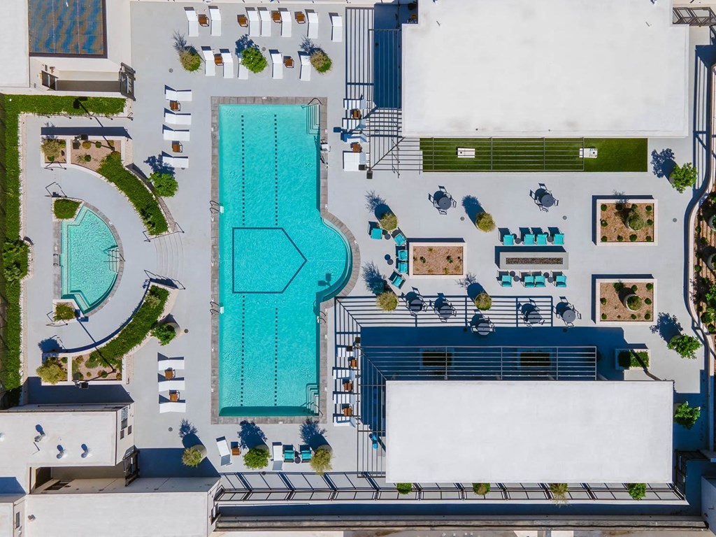 a birds eye view of the pool area of a resort with a swimming pool