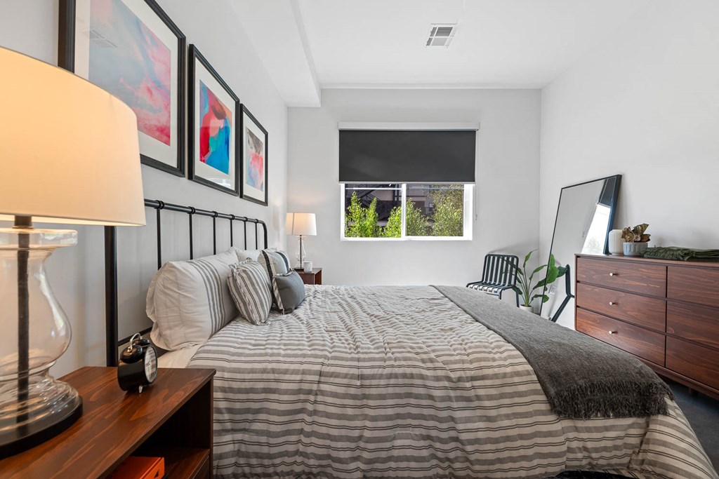 a bedroom with a bed and a window