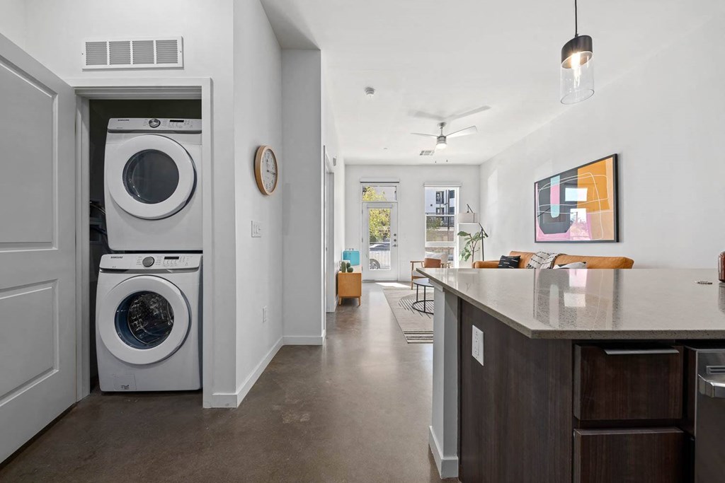 a kitchen with a washing machine and a washer in it