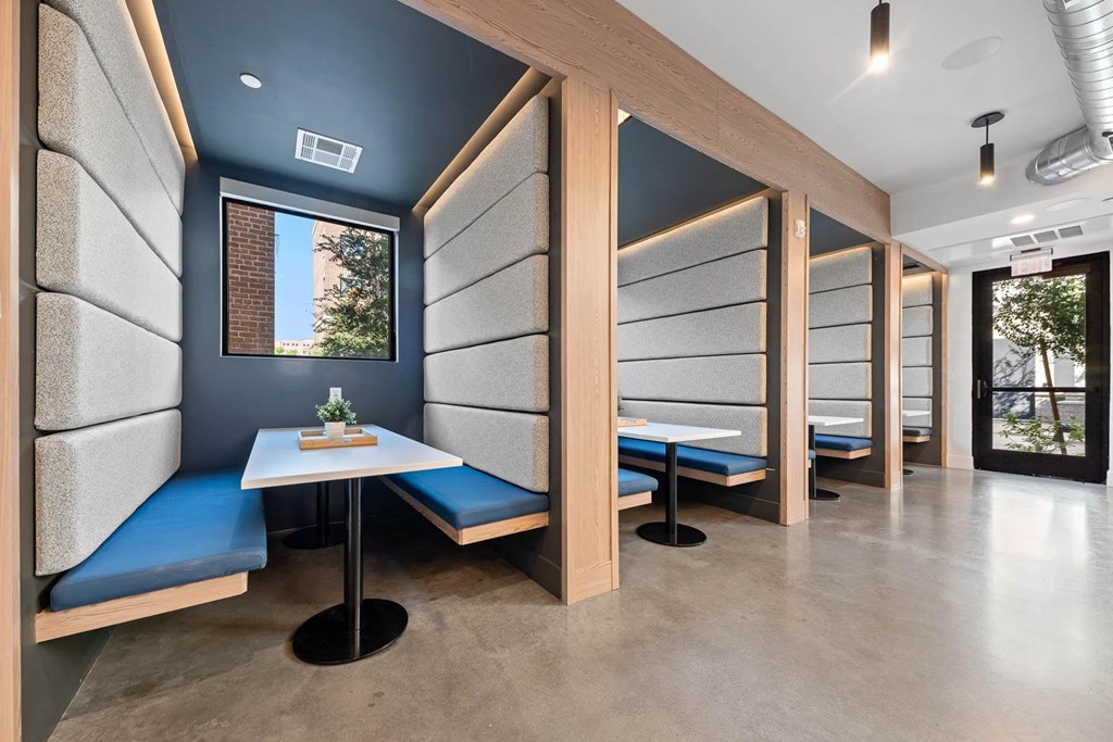 a restaurant with tables and benches in a room