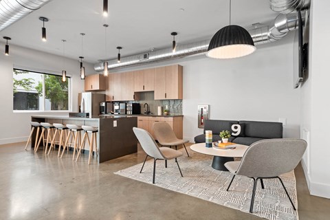 a kitchen and living room with a table and chairs