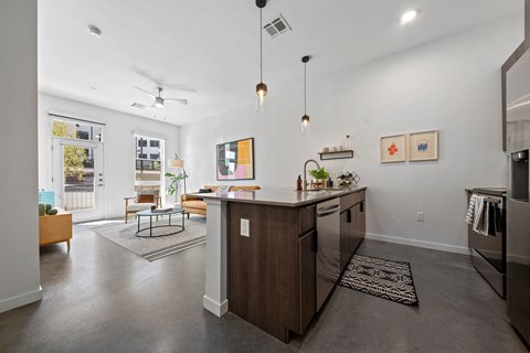 a kitchen with a center island and a living room