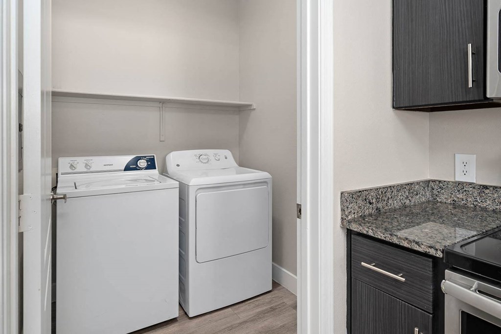 A laundry room with a washer and dryer in it