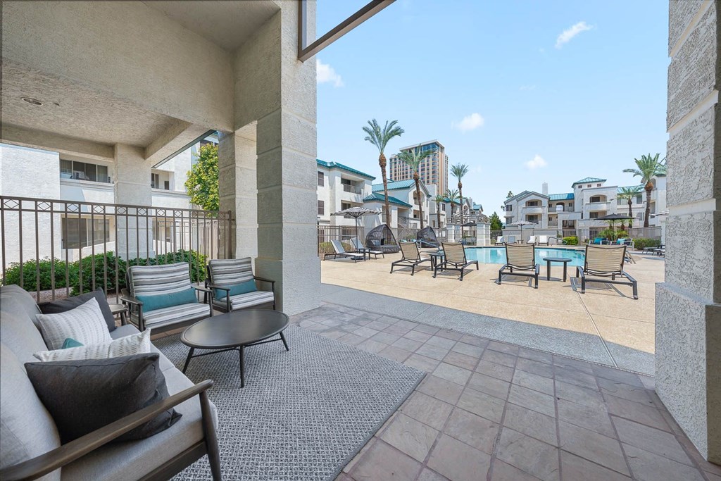 Exterior resort sytle pool and spa patio with chairs and tables