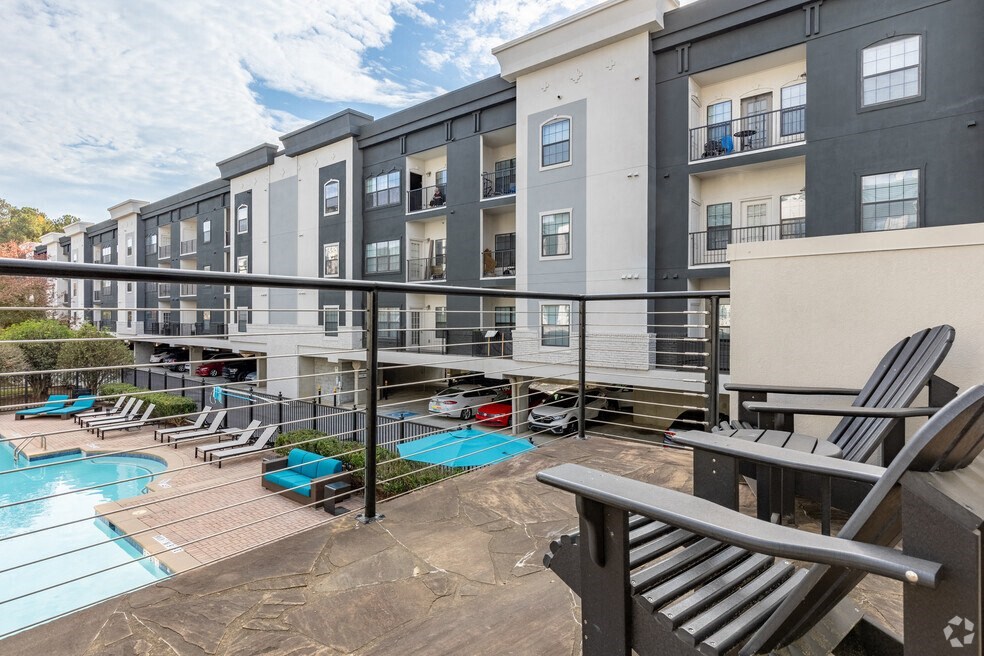 our apartments offer a pool and balcony with chairs and a table
