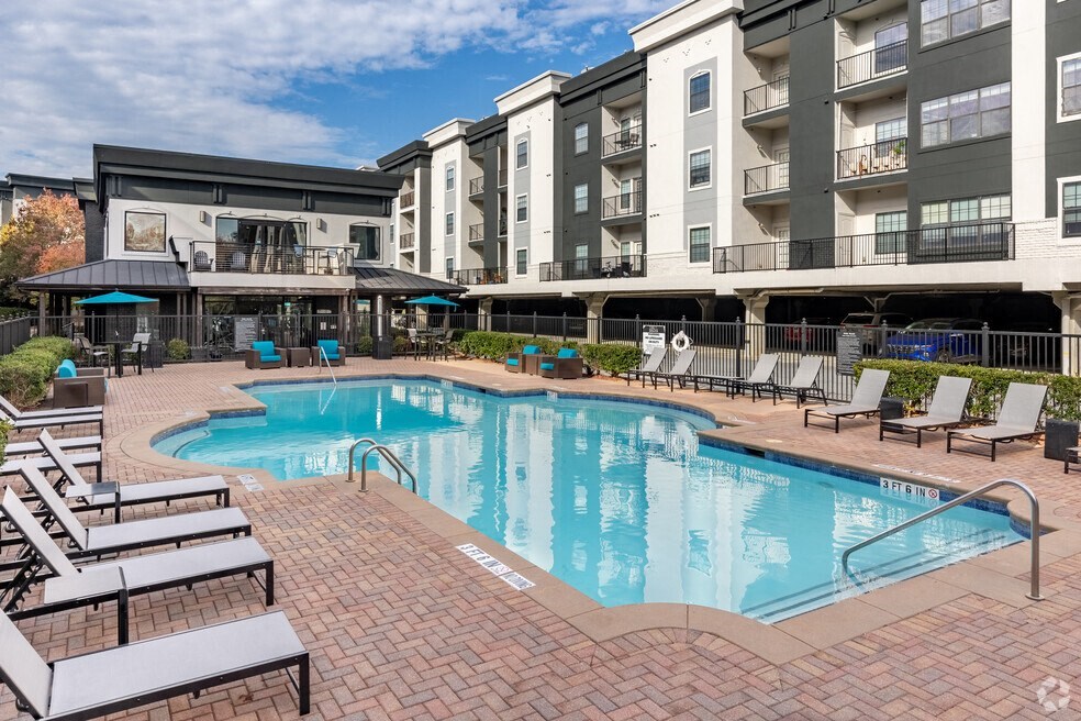 a swimming pool in front of an apartment building