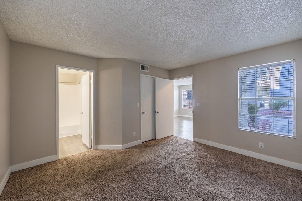 bedroom with a large window and carpeting
