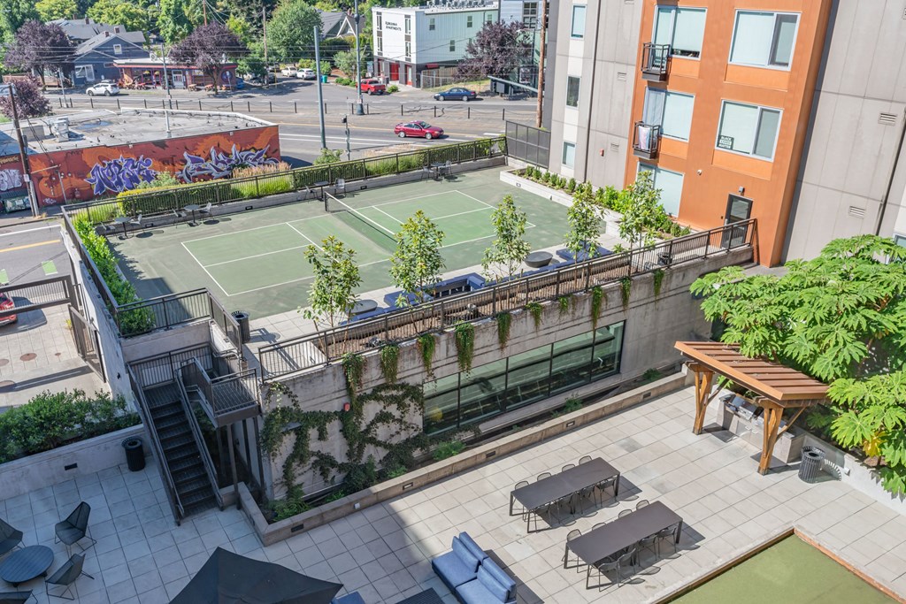 an aerial view of a tennis court on the roof of a building