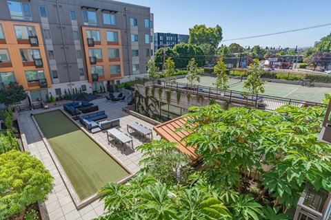 an aerial view of a courtyard with a ping pong table and a tennis court