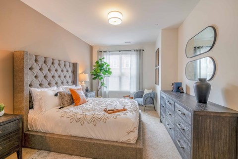 a bedroom with a bed and a dresser