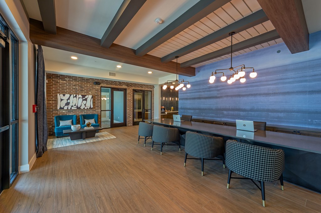 A modern room with a long table and chairs.