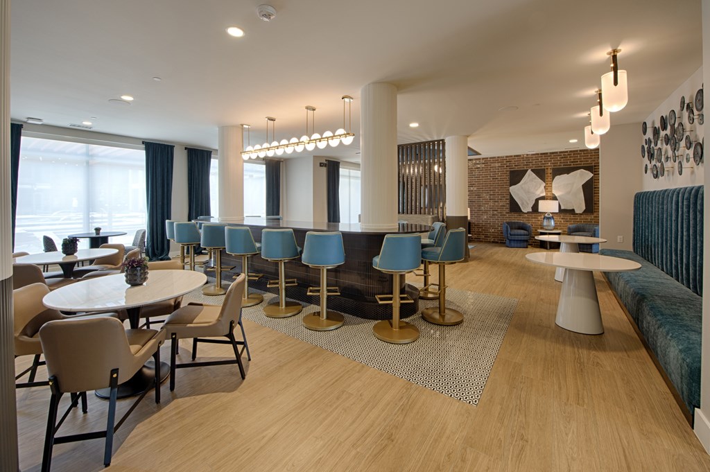 A modern dining room with a long table and chairs.