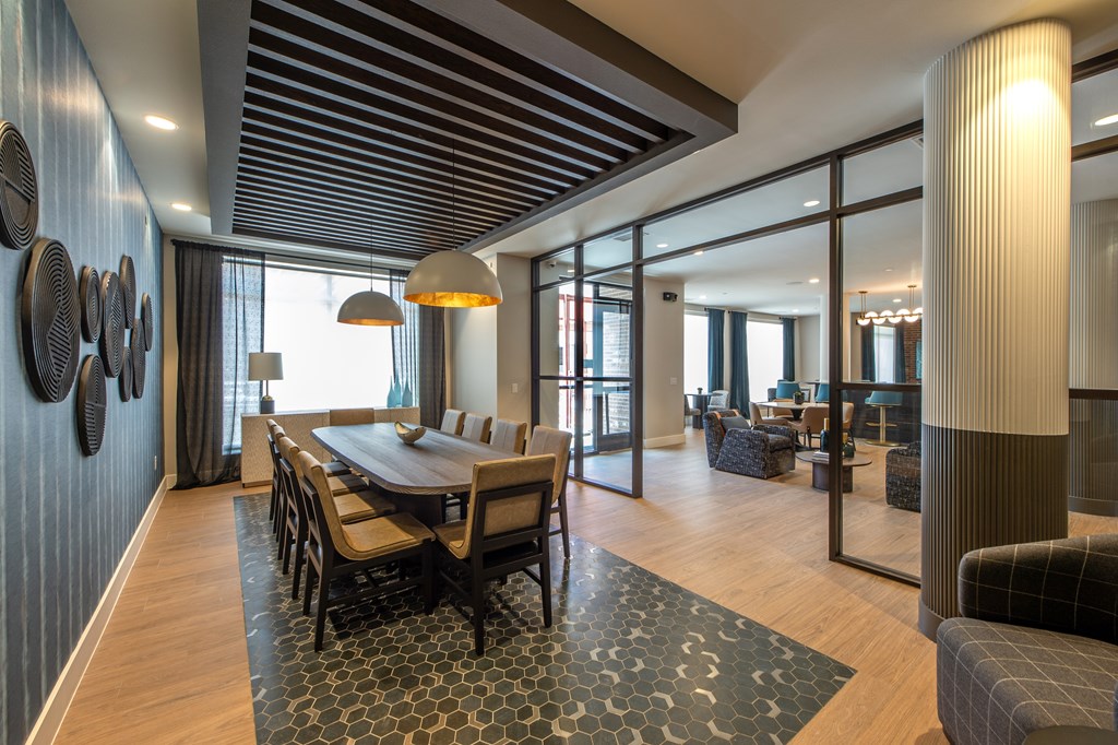A modern dining room with a wooden table and chairs.