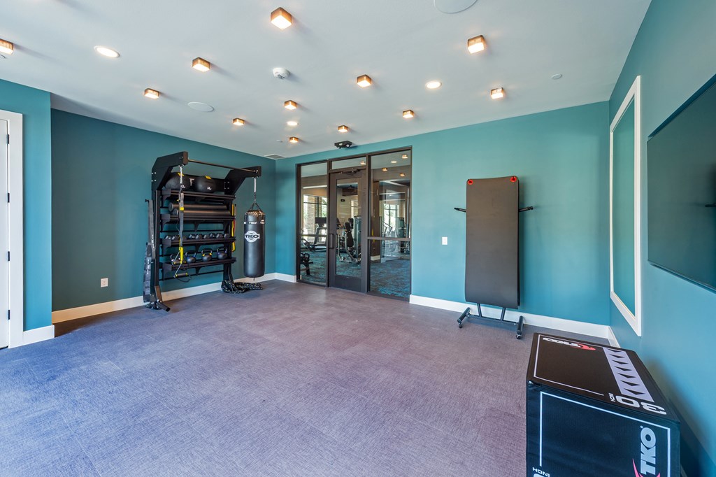 A room with a purple carpet and a black box on the floor.