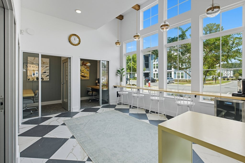 A white and black checkered floor in a room with a large window.