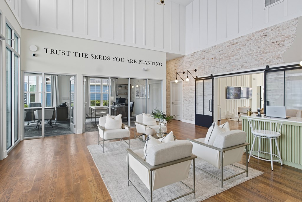 A living room with a sign that says "Trust the seeds you are planting".