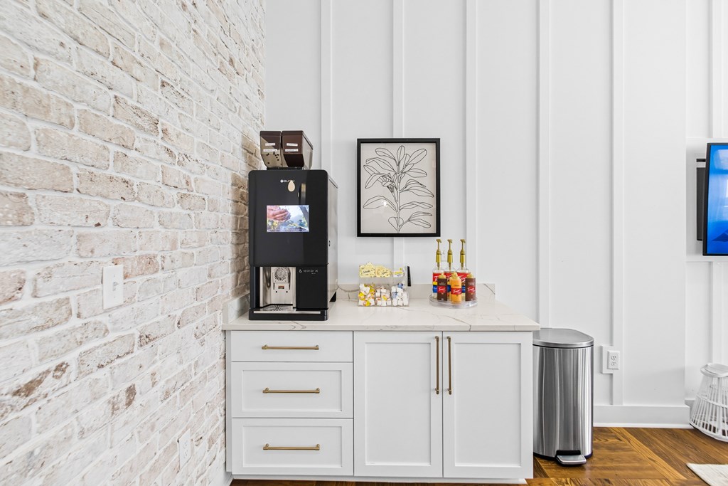 A white cabinet with a coffee maker on top of it.