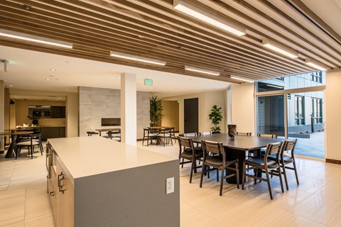 A modern dining area with a long table and chairs.